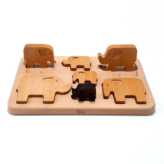 7 Wooden Elephants, to enjoy as a puzzle, as a stacker, or for imaginative play. Made of wood.