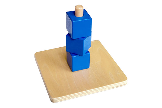 A classic Montessori toy, 3 cubes on a vertical dowel.