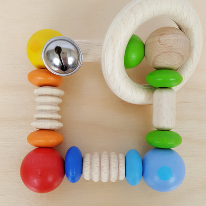 Wooden rattle with bell.